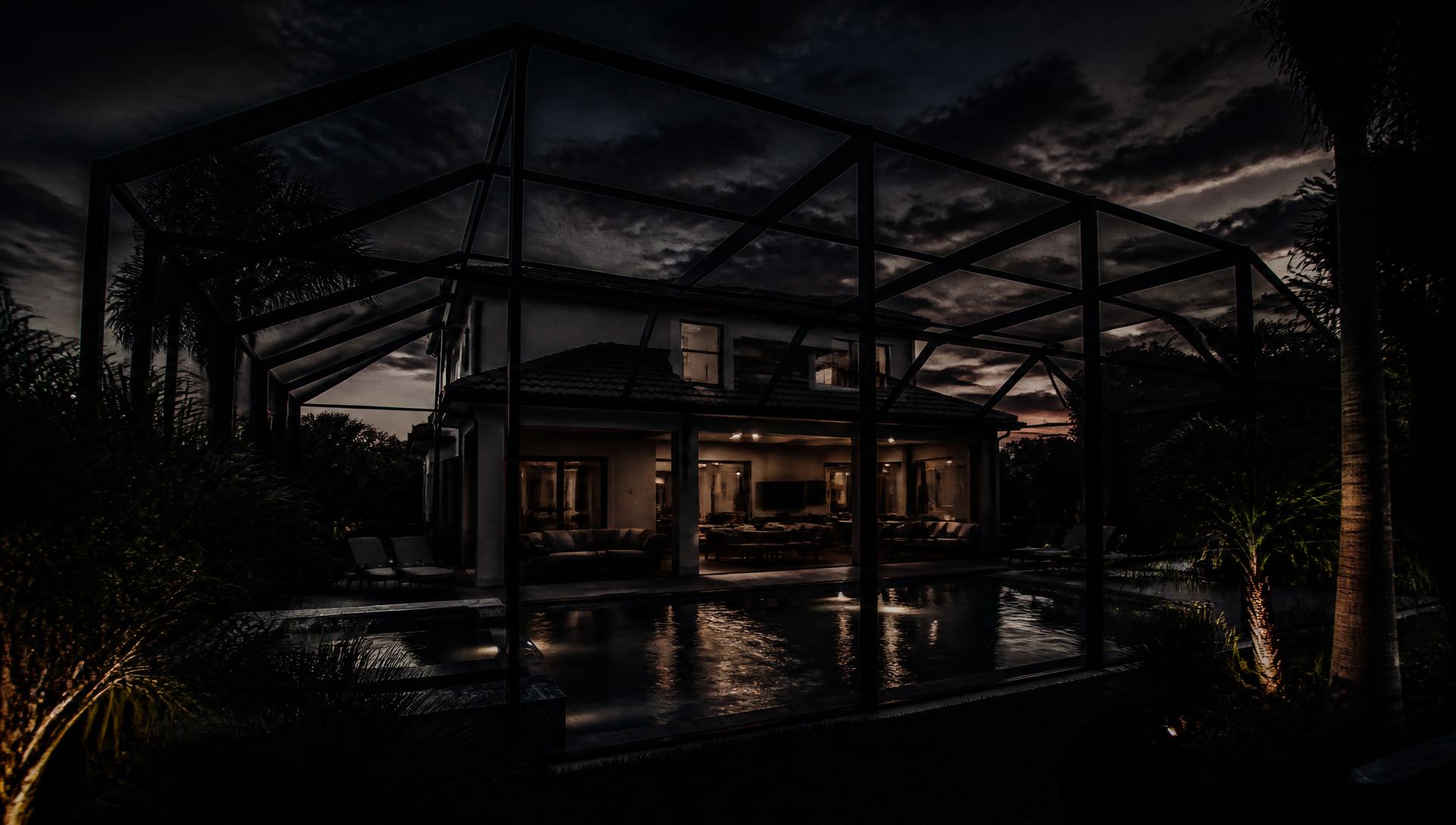 Aluminum pool enclosure over a luxury Central Florida home at sunrise
